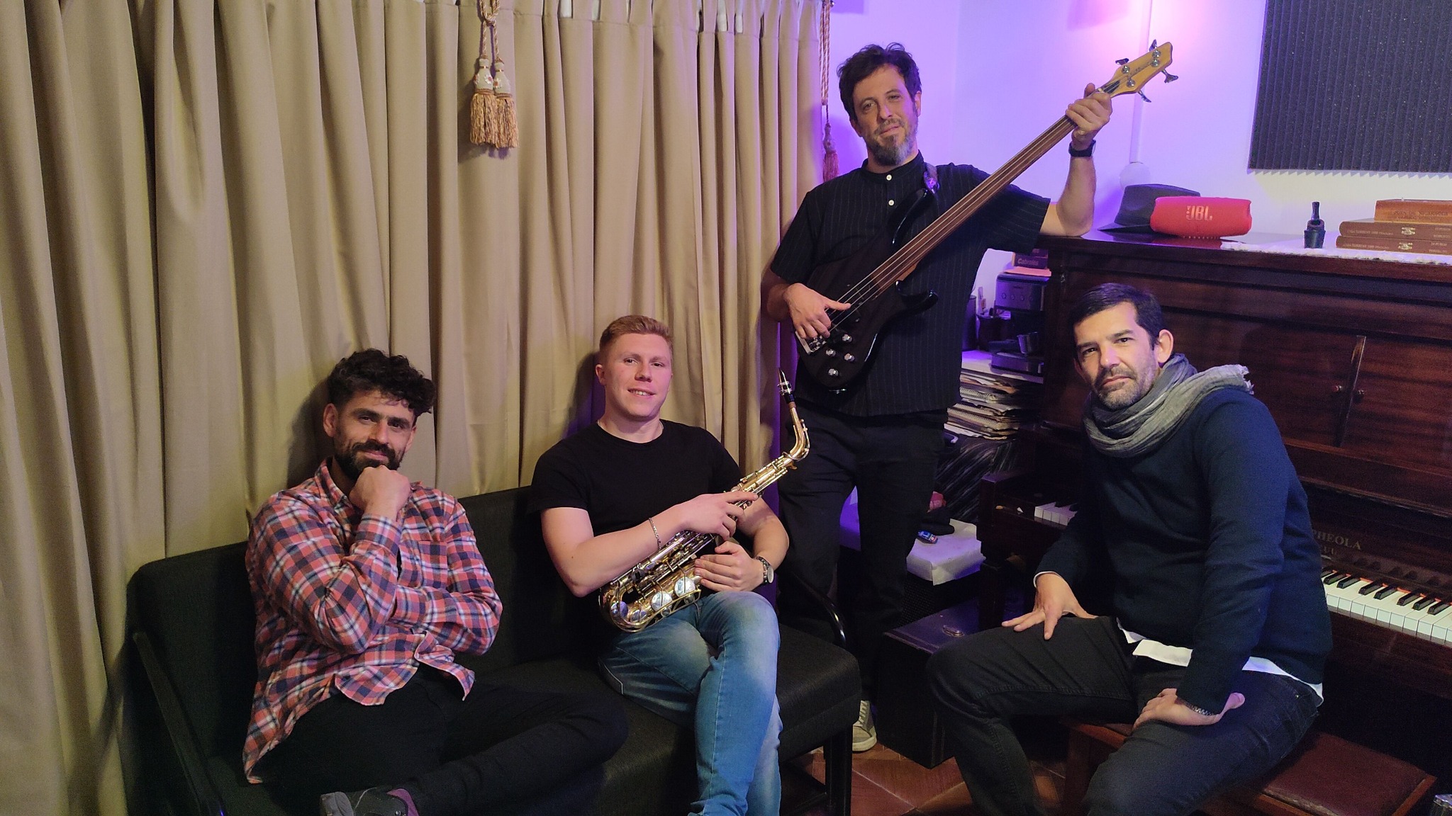 The four EchoSonic Studios musicians together with their instruments in the studio